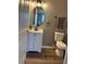 Bathroom with vanity and white cabinets, oval mirror, and tiled floors at 6258 Westcott Cove Blvd, Orlando, FL 32829