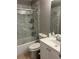 Bright bathroom featuring a vanity with a white countertop and a shower with glass doors and white marble tiling at 6258 Westcott Cove Blvd, Orlando, FL 32829
