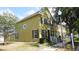 Well-maintained townhome featuring black shutters, attractive landscaping, and a charming architectural detail on the facade at 6258 Westcott Cove Blvd, Orlando, FL 32829
