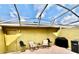 Enclosed patio with chairs, grill, brick pavers and access door to the home at 6258 Westcott Cove Blvd, Orlando, FL 32829