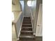 Elegant staircase featuring wood steps and white banisters at 6258 Westcott Cove Blvd, Orlando, FL 32829