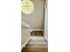 Stairwell with wood flooring and natural light from round window above at 6258 Westcott Cove Blvd, Orlando, FL 32829