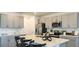 Modern kitchen with stainless steel appliances, white countertops, an island, and gray cabinets at 7315 Capstone Dr, Groveland, FL 34736