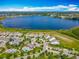 Stunning aerial view of waterfront community with lush landscaping, pool, and lake access at 7398 Alpine Butterfly Ln, Orlando, FL 32819