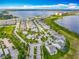 Wide aerial view of planned community, showcasing pool, landscaping and lakeside living at 7398 Alpine Butterfly Ln, Orlando, FL 32819