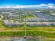 Beautiful aerial view of a modern residential neighborhood with a lake and a long wooden fishing pier at 7398 Alpine Butterfly Ln, Orlando, FL 32819