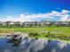 Stunning aerial view of waterfront homes with a private boat dock and lush green surroundings on a sunny day at 7398 Alpine Butterfly Ln, Orlando, FL 32819
