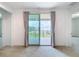 Bright room with sliding doors to a balcony and waterfront views framed by elegant curtains at 7398 Alpine Butterfly Ln, Orlando, FL 32819