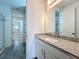 This bathroom features a granite countertop vanity, and tile flooring at 7398 Alpine Butterfly Ln, Orlando, FL 32819
