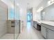 Modern bathroom features a glass-enclosed shower, double sinks, and stylish tile flooring at 7398 Alpine Butterfly Ln, Orlando, FL 32819
