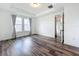 Bedroom features hardwood floors, neutral walls, and tray ceiling at 7398 Alpine Butterfly Ln, Orlando, FL 32819