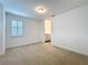 This bedroom features natural light from the window and adjoins the bathroom at 7398 Alpine Butterfly Ln, Orlando, FL 32819