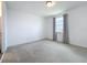 This bedroom features light gray curtains and view to an en suite bathroom at 7398 Alpine Butterfly Ln, Orlando, FL 32819