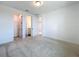 Light-filled bedroom featuring three doors leading to a closet, bathroom, and hallway at 7398 Alpine Butterfly Ln, Orlando, FL 32819