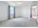 Bright bedroom with a large window overlooking the lake, neutral walls and plush carpeting at 7398 Alpine Butterfly Ln, Orlando, FL 32819