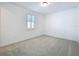 Bright bedroom with neutral carpet, white walls, and natural light from the window at 7398 Alpine Butterfly Ln, Orlando, FL 32819