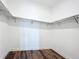 Walk-in closet offers ample storage space with built-in shelving and wood flooring at 7398 Alpine Butterfly Ln, Orlando, FL 32819