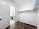 Walk-in closet features wood floors, wire shelving, and an open door to the bathroom at 7398 Alpine Butterfly Ln, Orlando, FL 32819