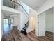 Spacious foyer with high ceilings, wood floors, and a view of the stairs and living area at 7398 Alpine Butterfly Ln, Orlando, FL 32819