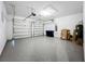 Two-car garage with epoxy flooring, two garage doors, and storage solutions at 7398 Alpine Butterfly Ln, Orlando, FL 32819