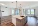 Kitchen island featuring gray cabinets, stainless steel appliances, a sink, and views of the lake at 7398 Alpine Butterfly Ln, Orlando, FL 32819