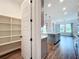 View of kitchen from pantry, showing the kitchen island and views of the lake from a nearby window at 7398 Alpine Butterfly Ln, Orlando, FL 32819
