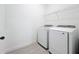 Laundry room featuring a washer, dryer, tile floor, and wire shelving at 7398 Alpine Butterfly Ln, Orlando, FL 32819