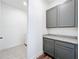 Gray cabinets and granite countertop are featured in this hallway outside the laundry room at 7398 Alpine Butterfly Ln, Orlando, FL 32819
