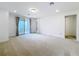 Spacious living room with carpet, recessed lighting, and sliding glass doors to a balcony with a water view at 7398 Alpine Butterfly Ln, Orlando, FL 32819