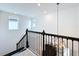 Stylish staircase with dark railings and a modern chandelier hanging from the ceiling at 7398 Alpine Butterfly Ln, Orlando, FL 32819