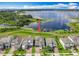 Beautiful waterfront property showcasing lush green lawns and lake access with a private dock at 7398 Alpine Butterfly Ln, Orlando, FL 32819