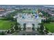 Stunning aerial view of the clubhouse and waterpark at Encore Resort, surrounded by palm trees and resort amenities at 7564 Marker Ave, Kissimmee, FL 34747