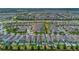 Expansive aerial view showcasing a community with many houses, each boasting private pools, and lush landscaping at 7564 Marker Ave, Kissimmee, FL 34747