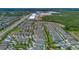 Aerial view of a residential area with community surrounded by green space and nearby commercial development at 7564 Marker Ave, Kissimmee, FL 34747