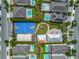 Overhead shot of community amenities like a playground, sports court, splashpad, and green spaces within a neighborhood at 7564 Marker Ave, Kissimmee, FL 34747