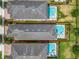 High-angle view of a home with private pool, neighboring residences, and well-kept gardens in a residential community at 7564 Marker Ave, Kissimmee, FL 34747