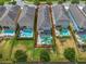 Aerial view of a luxury home featuring a private pool, spa, and well-manicured lawn and landscaping at 7564 Marker Ave, Kissimmee, FL 34747