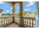A tiled balcony with decorative railings and views of the neighborhood at 7564 Marker Ave, Kissimmee, FL 34747