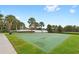 Community basketball court with mature landscaping, offering a recreational space for friendly games and exercise at 7564 Marker Ave, Kissimmee, FL 34747