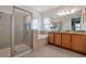 The bathroom features double sinks, granite countertops, a soaking tub, and a glass-enclosed shower at 7564 Marker Ave, Kissimmee, FL 34747