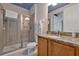 Bright bathroom featuring a glass enclosed shower, granite countertop, and neutral color palette at 7564 Marker Ave, Kissimmee, FL 34747