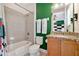 Bright bathroom features a shower-tub combination and a granite vanity at 7564 Marker Ave, Kissimmee, FL 34747