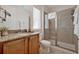 Well-lit bathroom featuring a shower, granite vanity, and linen closet at 7564 Marker Ave, Kissimmee, FL 34747
