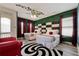 A whimsical bedroom boasts decorative red curtains, unique decor, and two full-sized beds at 7564 Marker Ave, Kissimmee, FL 34747