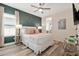 Cozy bedroom with modern ceiling fan, complementary decor, and attractive wood flooring at 7564 Marker Ave, Kissimmee, FL 34747