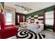 A whimsical bedroom with red curtains features unique furniture and decor at 7564 Marker Ave, Kissimmee, FL 34747