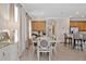 Dining area shows large table, decor, window shades, and transitions into the kitchen area at 7564 Marker Ave, Kissimmee, FL 34747