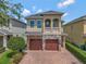 Charming two-story home showcasing a stone facade, a brick driveway, and a second story balcony at 7564 Marker Ave, Kissimmee, FL 34747