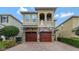 Charming home featuring a stone facade, two-car garage, and a well-manicured front yard at 7564 Marker Ave, Kissimmee, FL 34747