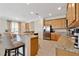 Spacious kitchen with granite countertops, stainless steel appliances, and bar seating at 7564 Marker Ave, Kissimmee, FL 34747